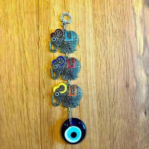 Evil Eye and Elephant wall pendant silver tone with glass evil eye.
